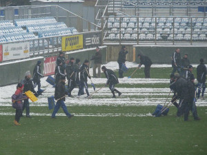 Odklízení sněhu na ploše hlavního stadionu na Střeleckém ostrově je v plném proudu