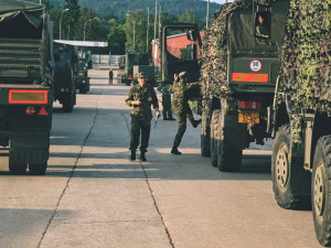 Příprava kolony vozidel ve vojenském autoparku.