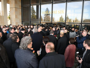 Smuteční hosté čekající na obřad.