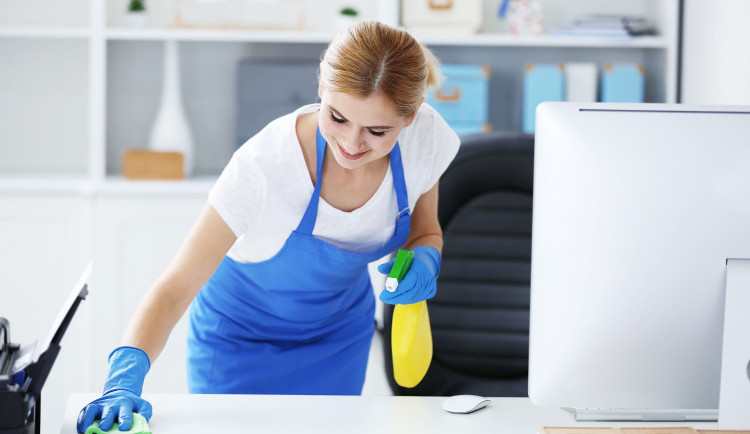 pretty-adult-woman-wiping-table-office