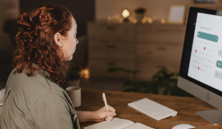 side-view-woman-home-using-her-computer