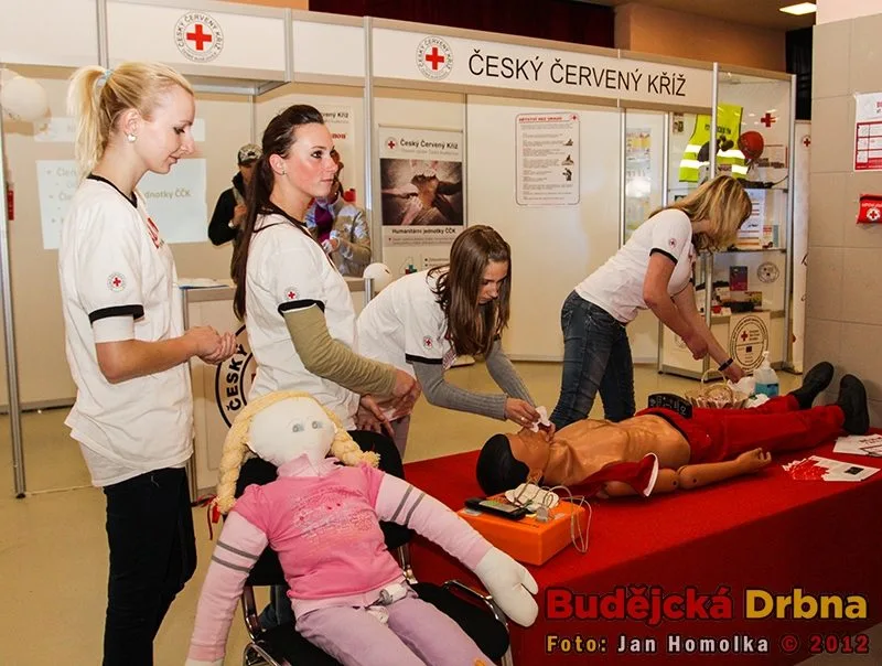 Slečny z Českého červeného kříže a trenažer srdeční masáže
