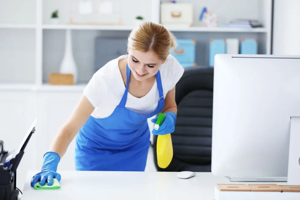 pretty-adult-woman-wiping-table-office