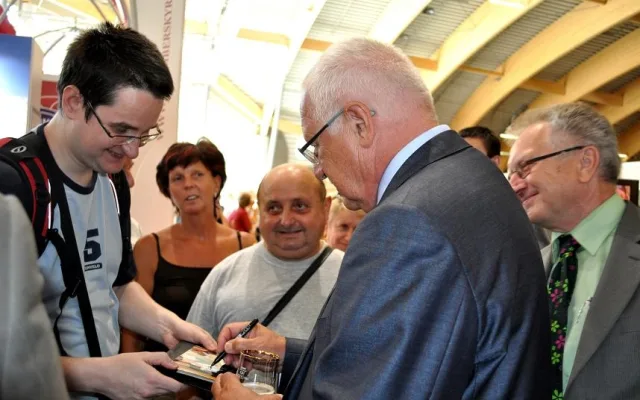 Prezident Václav Klaus během setkávání s návštěvníky výstavy podepisoval fotografie ( a propisky poctivě vracel)