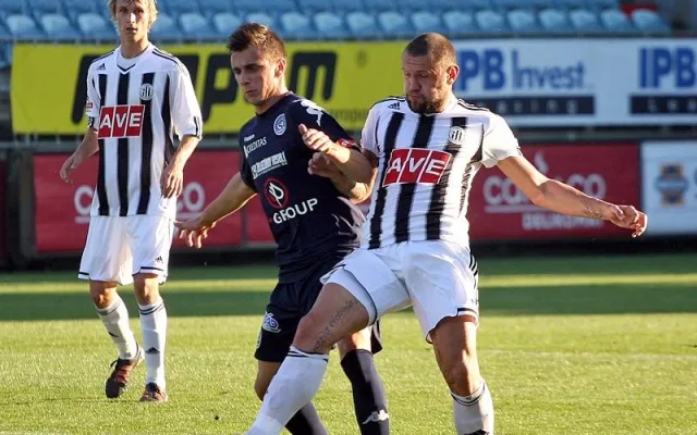 Stoper Dynama Jan Halama odehrává míč před Mariánem Kovářem