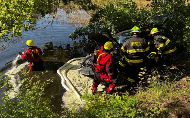 Auto sjelo do rybníka. Hasiči zachránili řidičku i psa