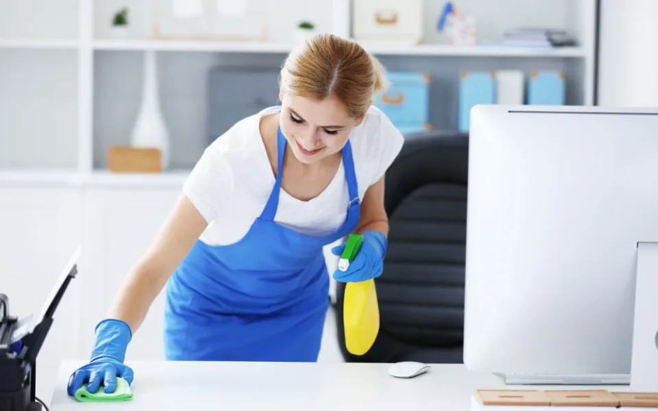 pretty-adult-woman-wiping-table-office