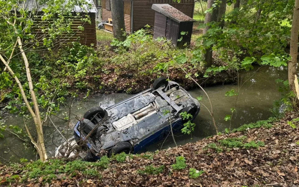 Auto skončilo na střeše v potoce. Řidiče, ženu i malé dítě zachránili pohotoví svědci